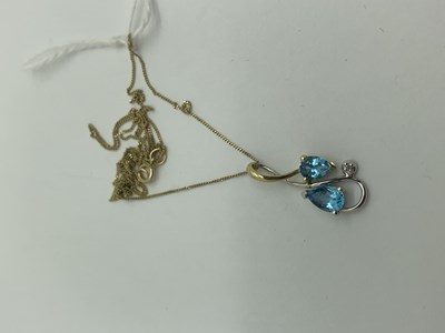 Lot 553 - A Modern Two Colour Pendant, claw set, stamped...