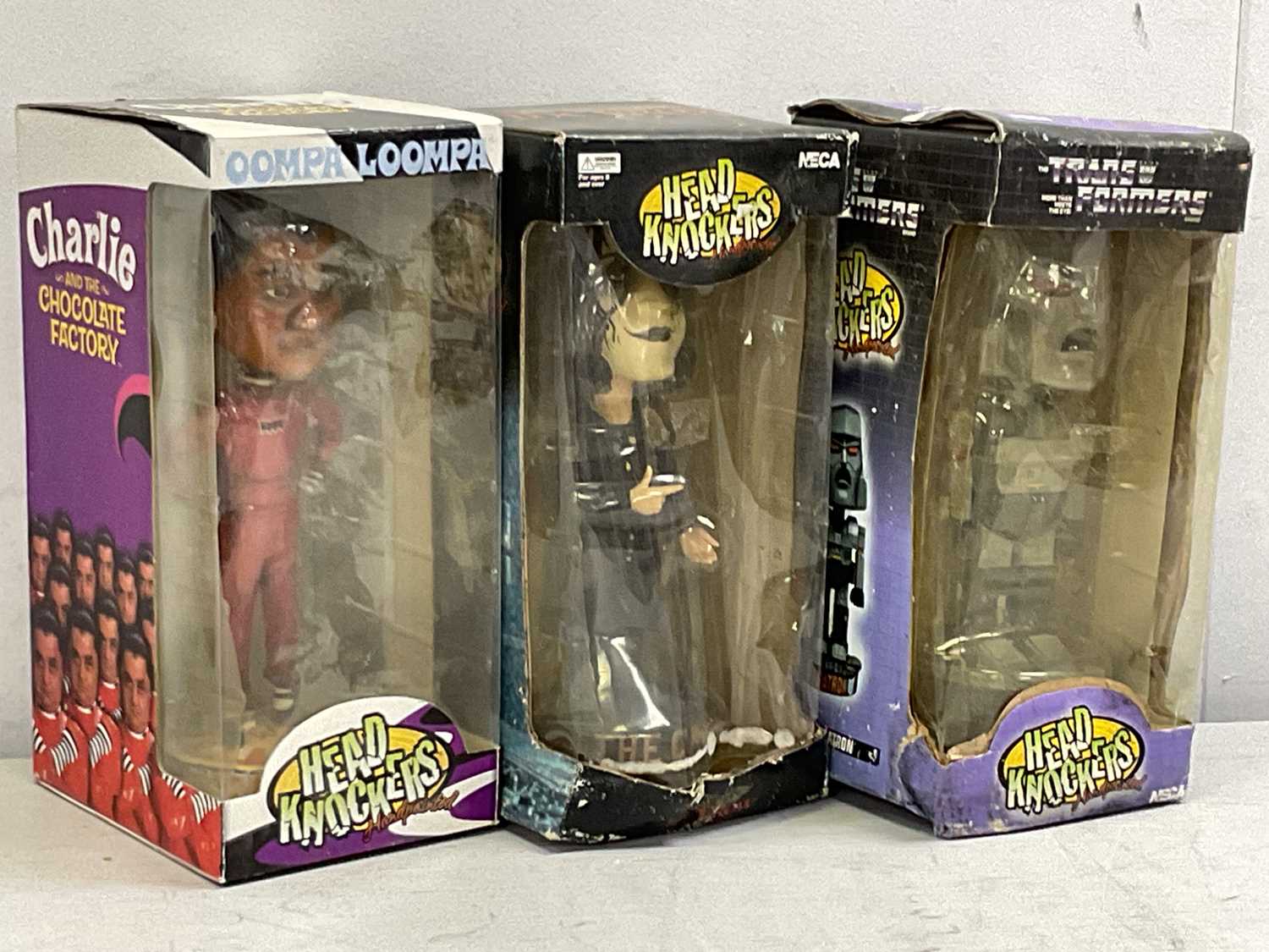 Lot 461 - Three Neca Head Knockers to include The Crow,...