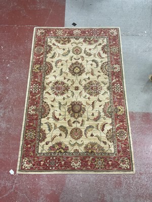 Lot 1521 - A Wool Rug, with a red ground border and...