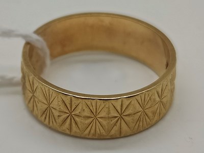 Lot 65 - A 9ct Gold Wide Textured Wedding Band, with...