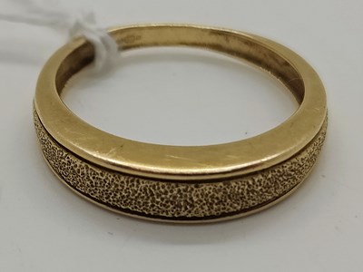 Lot 53 - A Textured Tapered Band Ring, stamped "585"...