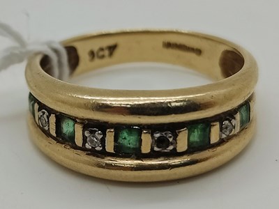 Lot 62 - A 9ct Gold Diamond and Emerald Nine Stone Ring,...