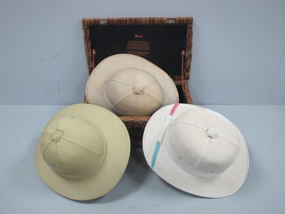 Lot 1110 - Harrod's Wicker Basket, three Pith Helmets.