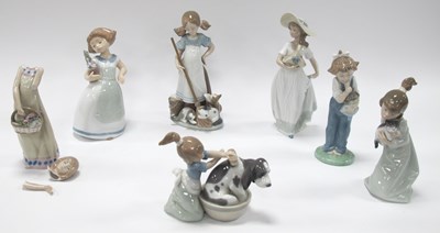 Lot 1219 - Four Lladro Figurines of Girls Holding a Cat,...