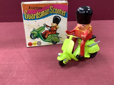 Lot 908 - A Hong Kong Plastic Friction Guardsman Scooter,...