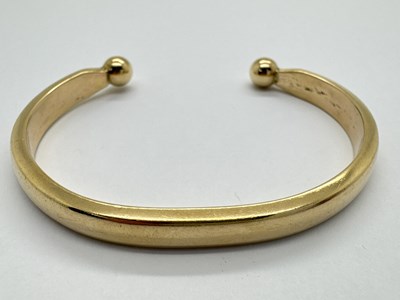 Lot 216 - A Vintage Solid Cuff Bangle, of plain tapered...