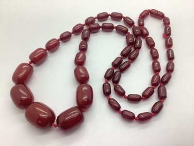 Lot 184 - A Cherry Amber Coloured Bead Necklace,...