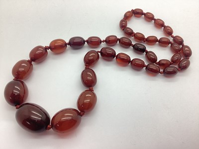 Lot 185 - A Cherry Amber Coloured Bead Necklace,...