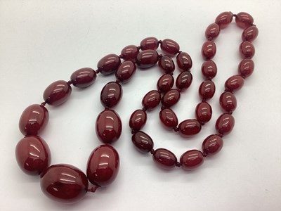 Lot 183 - A Cherry Amber Coloured Bead Necklace,...
