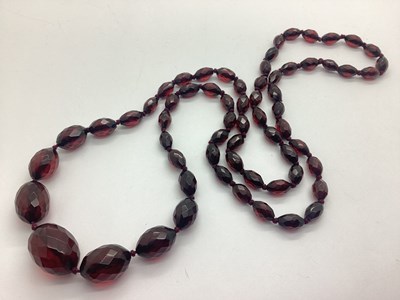 Lot 179 - A Cherry Amber Coloured Faceted Beaded...