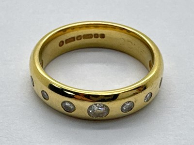Lot 235 - A Modern 18ct Gold Dimond Set Band, rubover...