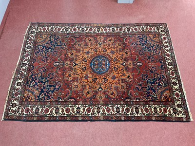 Lot 1455 - A Middle Eastern Wool Rug, in shades of orange,...