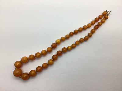 Lot 156 - A Single Strand Amber Coloured Bead Necklace,...