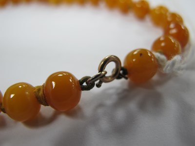 Lot 156 - A Single Strand Amber Coloured Bead Necklace,...