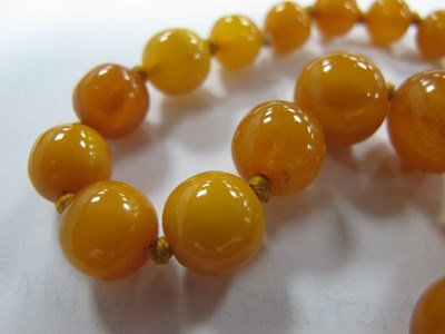Lot 156 - A Single Strand Amber Coloured Bead Necklace,...