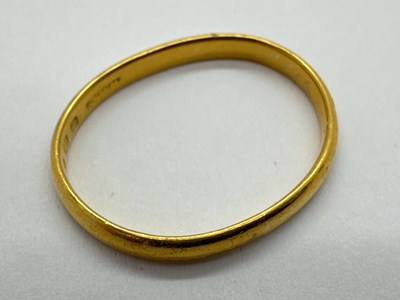 Lot 65 - A 22ct Gold Slim Wedding Band, of plain design...