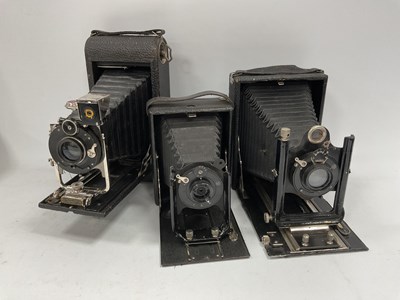 Lot 1402 - Three Vintage Folding Cameras - a large Kodak...