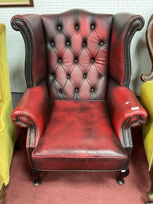 Lot 1508 - Ox Blood Wing Armchair, with a button back...