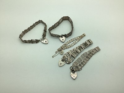 Lot 224 - Five Gate Link Style Bracelets, each to a...