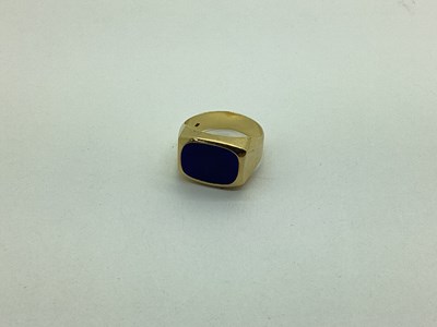 Lot 250 - A Lapis Lazuli Inset Gent's Ring, rubover set,...