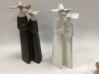 Lot 1186 - Lladro Pottery Two Nun Figure Groups, one in...