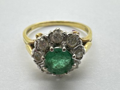 Lot 65 - An 18ct Gold Emerald and Diamond Cluster Ring,...