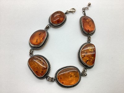 Lot 131 - An Amber Coloured Inset Panel Bracelet, each...