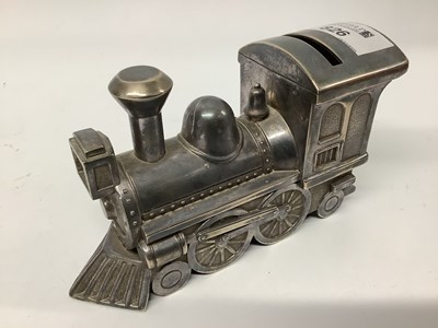 Lot 826 - A metal money box in the shape of an old...
