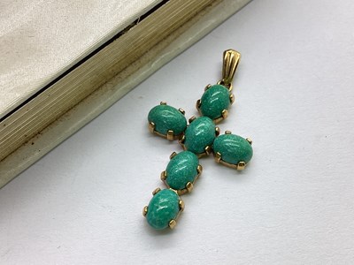 Lot 69 - A 9ct Gold Stone Set Cross Pendant, the oval...