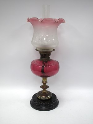 Lot 1450 - A Cranberry Glass and Brass Oil Lamp, with...