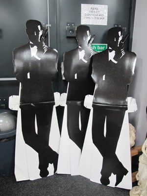 Lot 1003 - Three life-sized cardboard cutouts of James Bond.