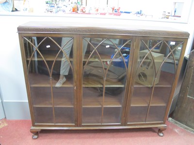 Lot 1499 - An Astragal Glazed Three Door Bookcase in dark...