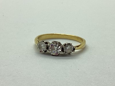 Lot 44 - A Three Stone Diamond Ring, graduated claw set...
