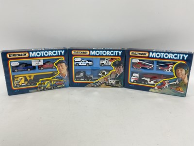 Lot 709 - Three Matchbox Motorcity Diecast Model Vehicle...
