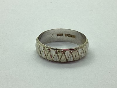 Lot 42 - An 18ct White Gold Wedding Band, of abstract...
