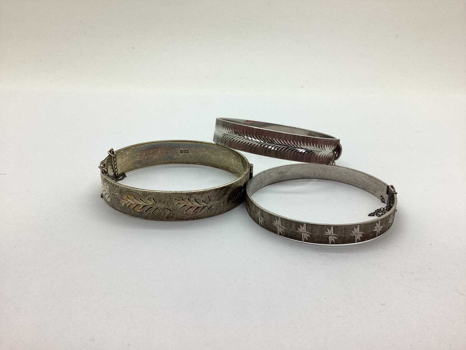 Lot 190 - A Hallmarked Silver Hinged Bangle, with an...