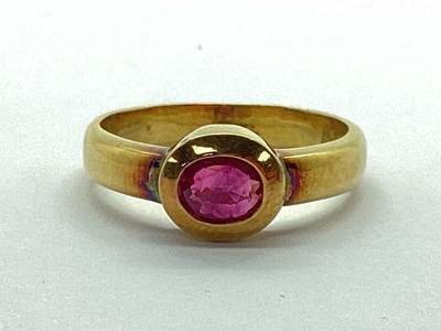 Lot 70 - A Modern Single Stone Ruby Ring, oval rubover...