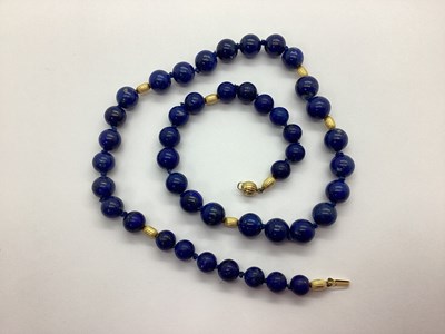 Lot 117 - A Lapis Lazuli Bead Necklace, knotted to...