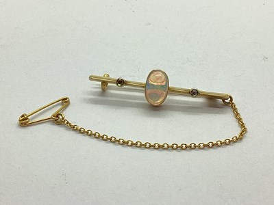 Lot 175 - An Opal and Diamond Bar Brooch, oval cabochon...
