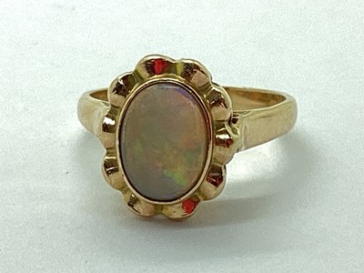 Lot 99 - A Modern Opal Dress Ring, the oval cabochon...