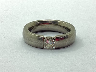Lot 61 - A Modern Titanium Diamond Set Ring, the inset...
