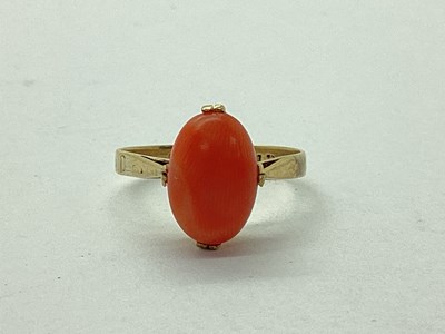 Lot 100 - A Coral Dress Ring, cabochon claw set stone,...