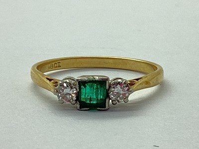 Lot 82 - A Modern Emerald and Diamond Three Stone Ring,...
