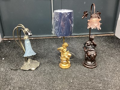 Lot 1590 - A lamp cast figure of a lady reading book with...