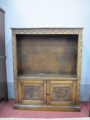 Lot 1592 - XX Century Oak Bookcase, with a carved frieze...