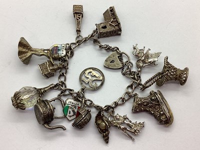 Lot 125 - A Curb Link Charm Bracelet, to heart shape...