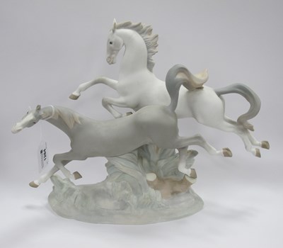 Lot 1284 - Lladro Galloping Horses Figure Group, on oval...