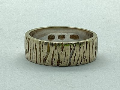 Lot 30 - An 18ct White Gold Textured Wedding Band,...