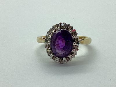 Lot 34 - A 9ct Gold Amethyst and Diamond Oval Cluster...