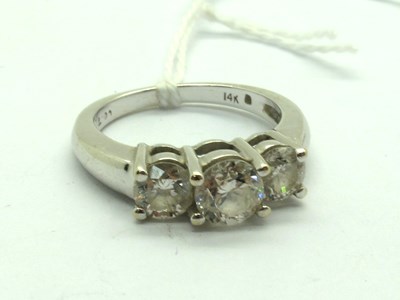 Lot 213 - A Modern Three Stone Diamond Ring, the high...